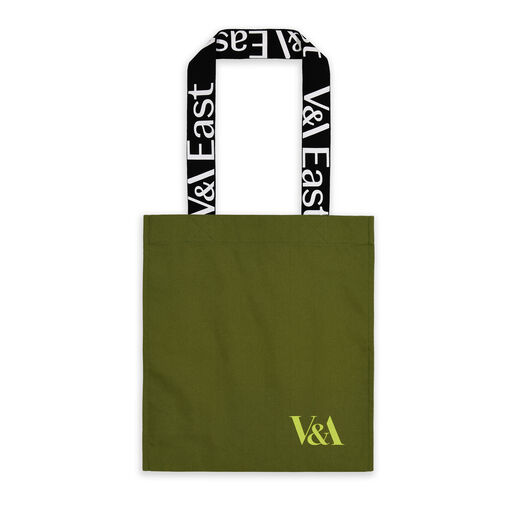 A khaki green tote with graphic typographic handle reading "V&A EAST" - branded for the new V&A EAST Museum and Storehouse